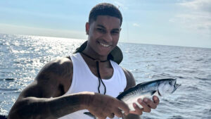 Man Utd outcast Marcus Rashford beams as he enjoys Barcelona downtime with a spot of fishing on yacht