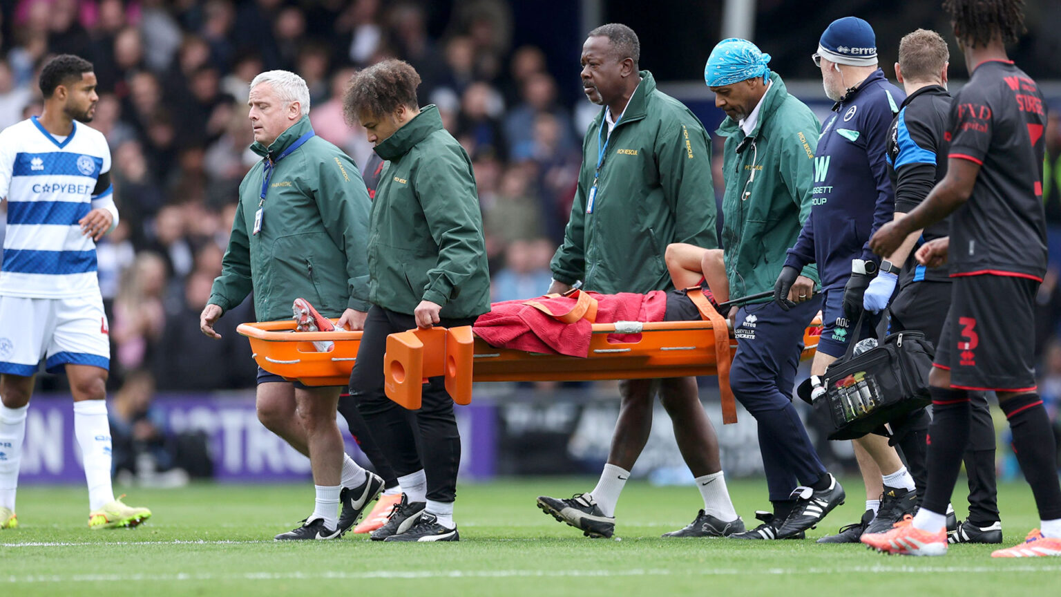 Millwall star Massimo Luongo carried off on stretcher against QPR as all four stands applaud stricken midfielder