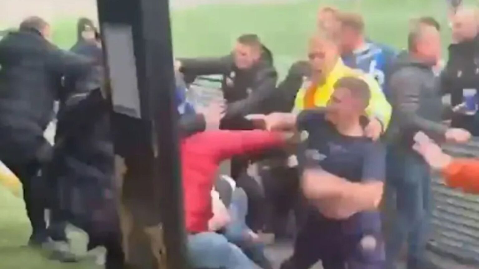 Football match descends into chaos when players on team losing 6-0 storm stands and erupt into brawl with fans