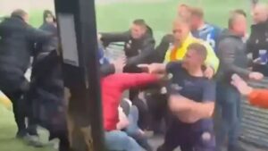 Football match descends into chaos when players on team losing 6-0 storm stands and erupt into brawl with fans