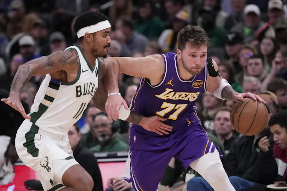The Lakers' Luka Doncic drives past the Bucks' Gary Harris on Saturday in Milwaukee.