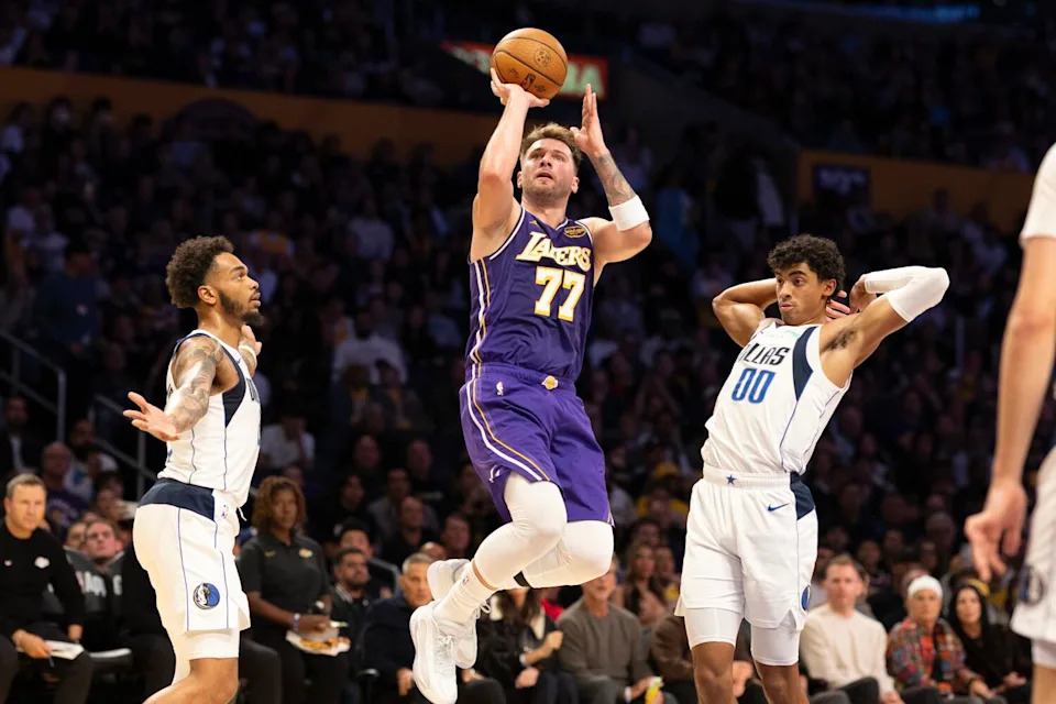 Lakers guard Luka Doncic puts up a jumper between Dallas Mavericks forward P.J. Washington and guard Max Christie.