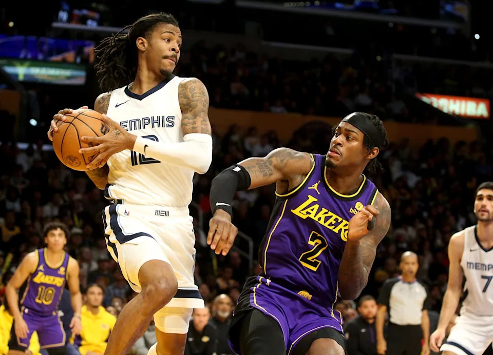 Grizzlies guard Ja Morant, left, grabs a rebound in front of Lakers forward Jarred Vanderbilt.