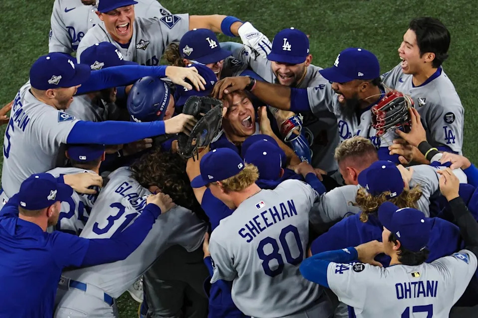 Pitcher Yoshinobu Yamamoto of the Dodgers (R) celebrates with teammates after defeating the Blue Jays. Getty Images