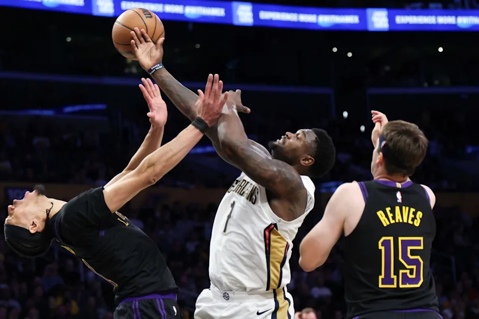 Lakers center Jaxson Hayes takes a charge and falls after getting hit by Pelicans forward Zion Williamson.