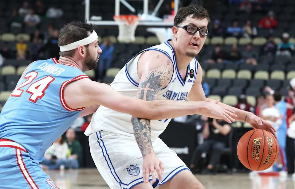 Saint Louis Billikens center Robbie Avila (21) handles the ball against Dayton Flyers forward Jacob Conner (24) during the second half in an Atlantic 10 Conference Tournament Semifinal game at PPG Paints Arena.