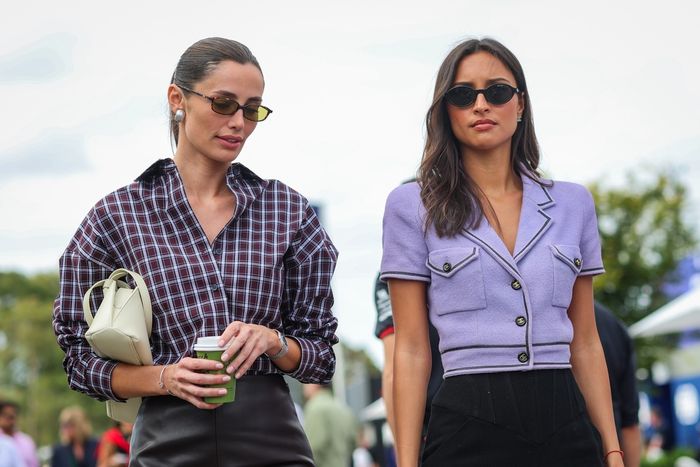  Alexandra Leclerc, wife of Charles Leclerc of Monaco and Ferrari, walks in the paddock with model and girlfriend of Carlos Sainz of Spain and Williams, Rebecca Donldsonduring