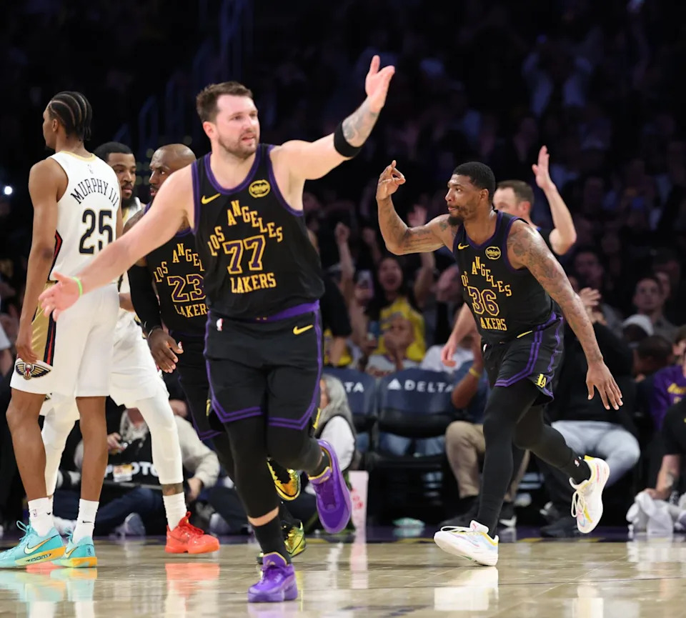 Lakers guard Luka Doncic motions across the court after Marcus Smart hit a three-pointer late in a win over the Pelicans