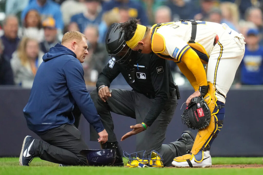 C.B. Bucknor helped off field by trainers after taking foul ball directly to the face mask