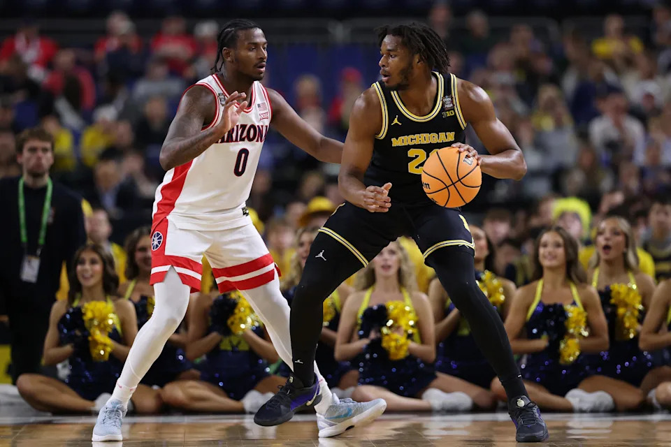 Morez Johnson Jr. #21 of the Michigan Wolverines is defended by Jaden Bradley #0 of the Arizona Wildcats in the Final Four of the 2026 NCAA Men's Basketball Tournament at Lucas Oil Stadium on April 04, 2026 in Indianapolis, Indiana.