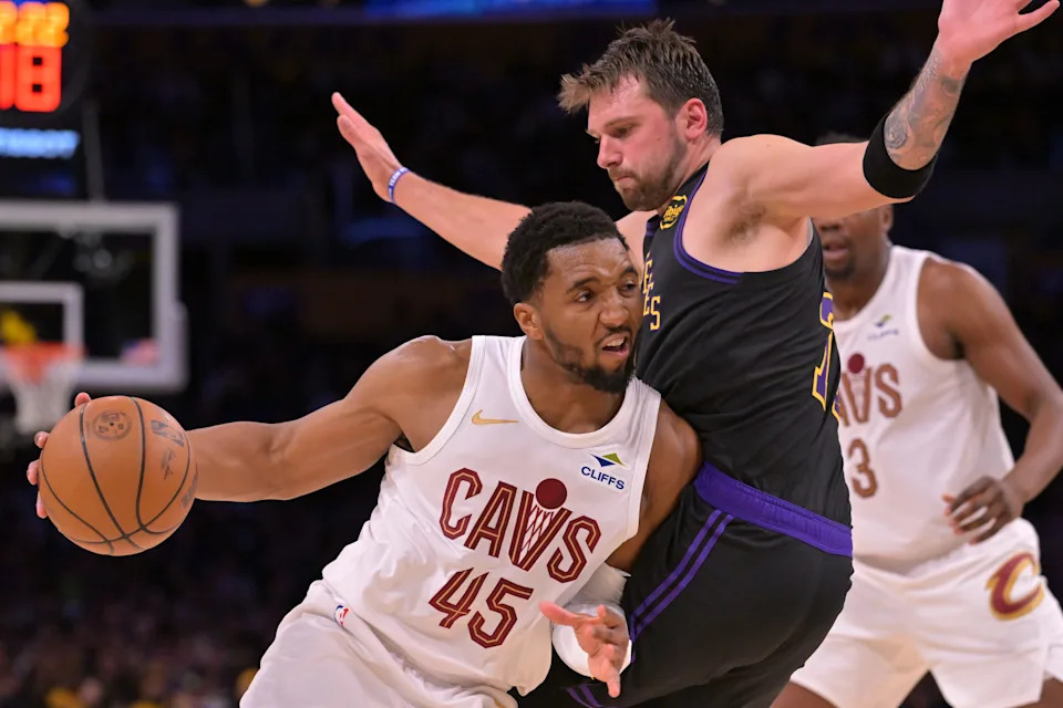 Cleveland Cavaliers guard Donovan Mitchell (45) is defended by Los Angeles Lakers guard Luka Doncic (77) as he drives to the basket during their game on March 31, 2026.