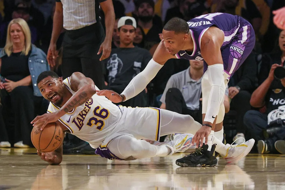 Lakers guard Marcus Smart looks to pass after chasing down a loose ball under pressure from the Kings' Russell Westbrook
