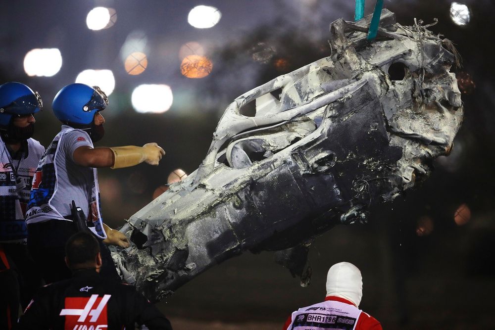 Marshals remove the wreckage after Romain Grosjean, Haas VF-20 crash