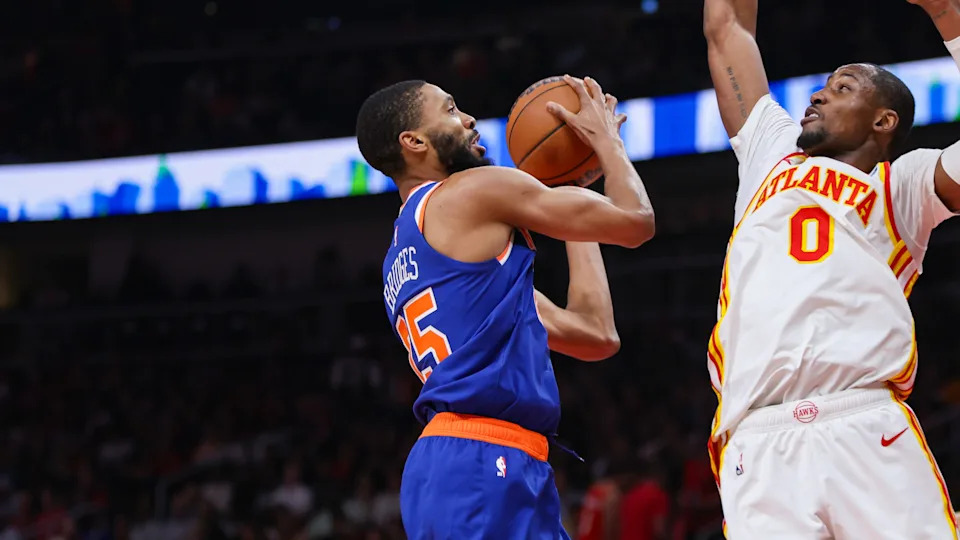 Apr 30, 2026; Atlanta, Georgia, USA; New York Knicks guard Mikal Bridges (25) shoots past Atlanta Hawks forward Jonathan Kuminga (0) in the second quarter during game six of the first round of the 2026 NBA Playoffs at State Farm Arena. Mandatory Credit: Brett Davis-Imagn Images