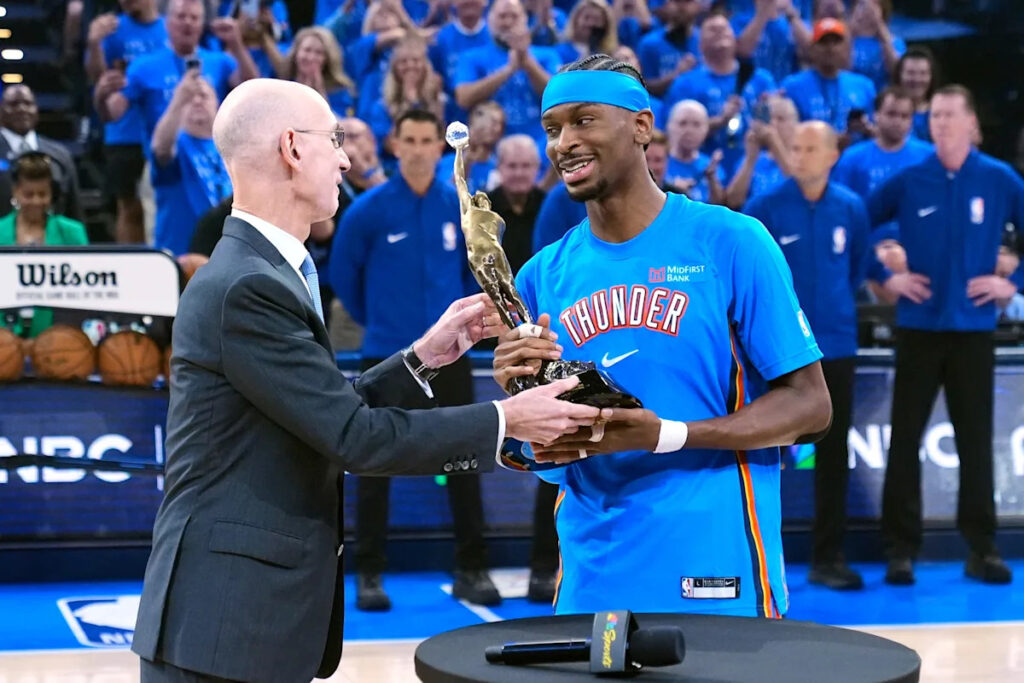 Shai Gilgeous-Alexander gets the MVP trophy from NBA Commissioner Adam Silver