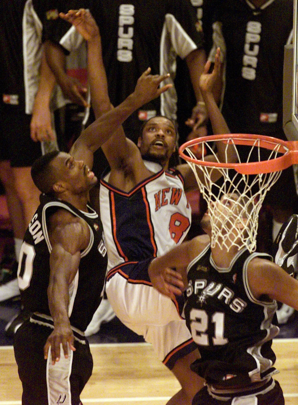 San Antonio Spurs big men David Robinson, left, and Tim Duncan defend as New York Knicks guard Latrell Sprewell launches a last-second shot in Game 5 of the 1999 NBA Finals at Madison Square Garden.
