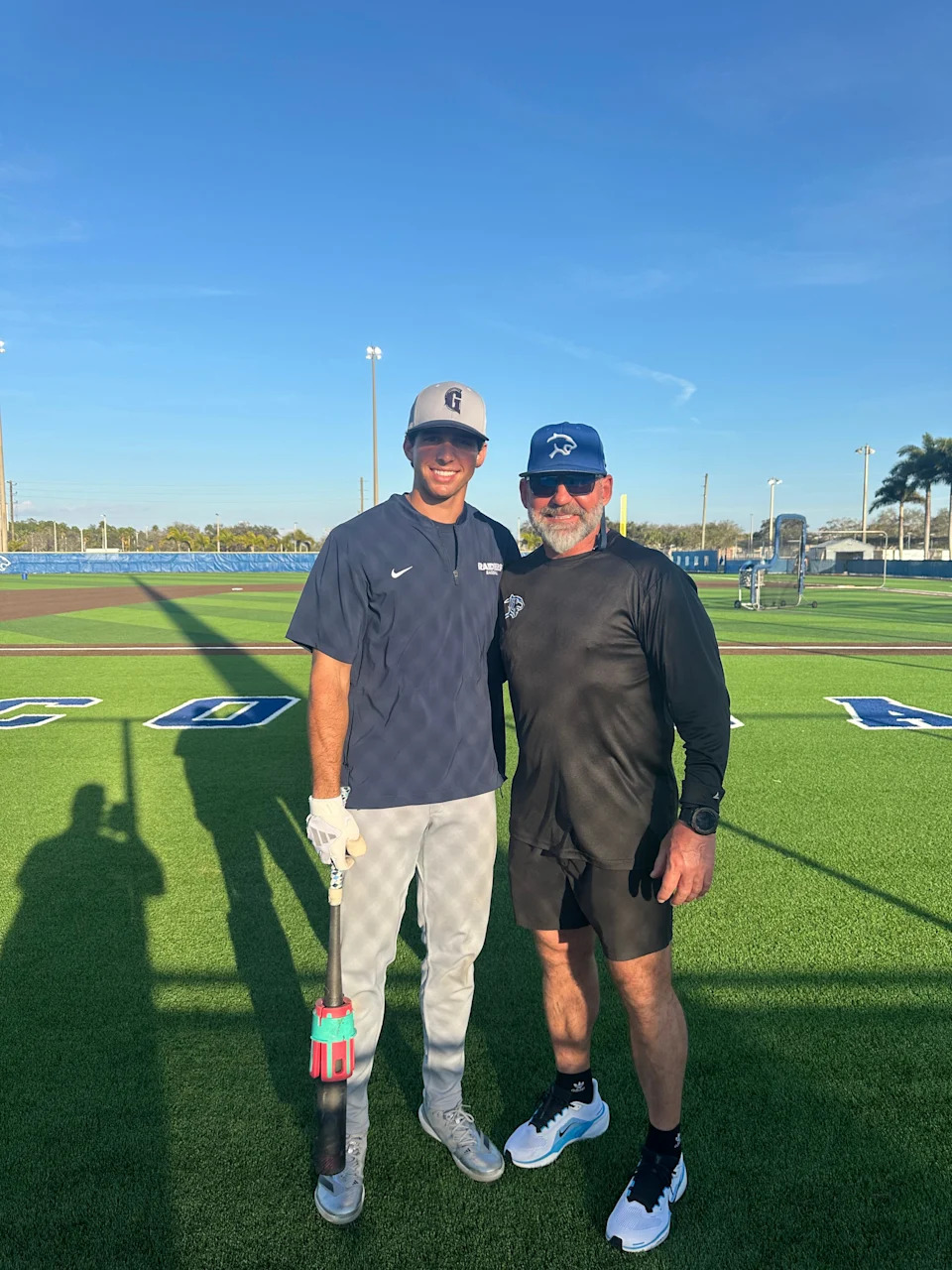 Gulliver Prep shortstop Jacob Lombard (left) and Barron Collier coach Adam Johnson (right) pose for a picture before their game against one another on Thursday, Feb. 19, 2026.