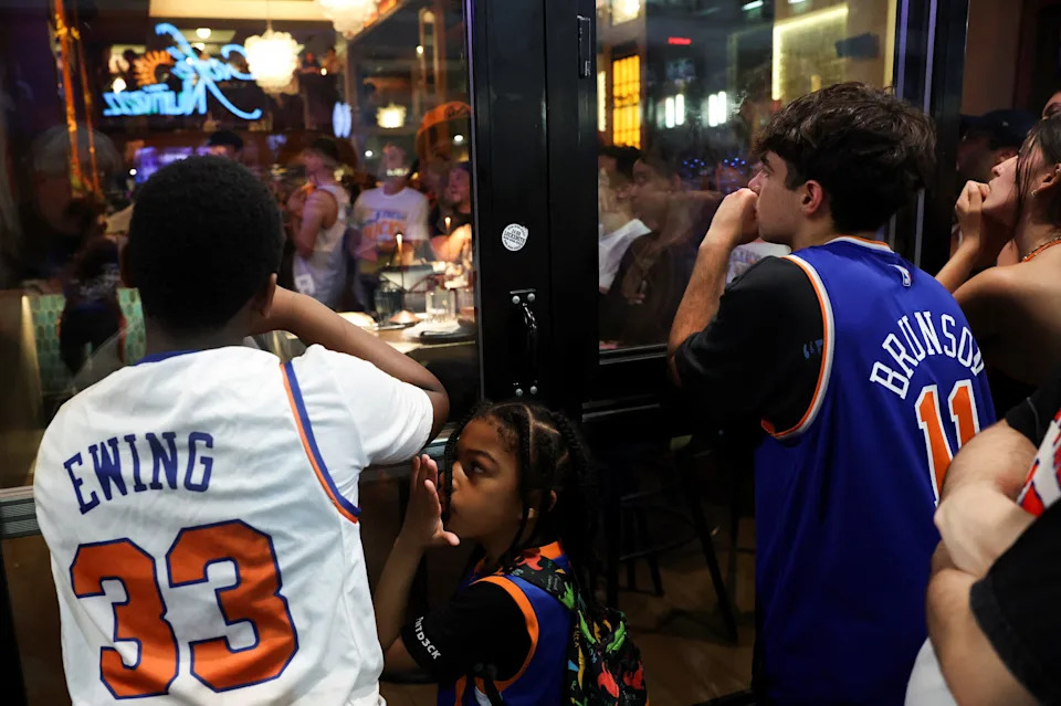 Fans gather outside a bar to watch the screening of Game 4 of the NBA Finals between the New York Knicks and San Antonio Spurs, near Madison Square Garden in New York City, on June 10, 2026.