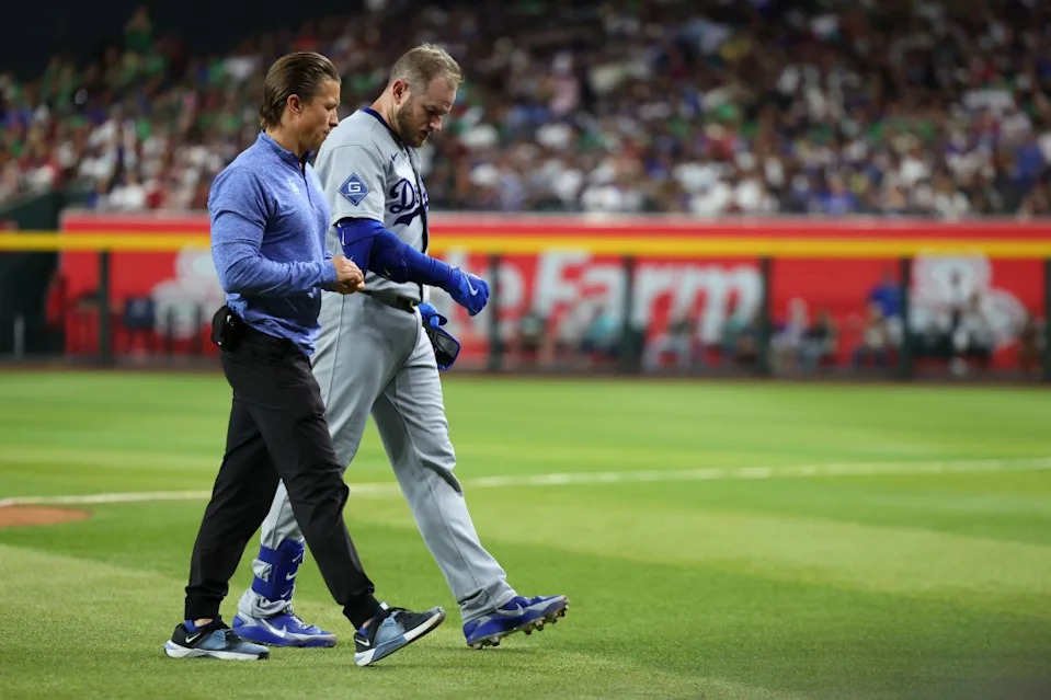Max Muncy walks off the field with an apparent injury after colliding with Arizona Diamondbacks first baseman Ildemaro Vargas. Anna Carrington-Imagn Images