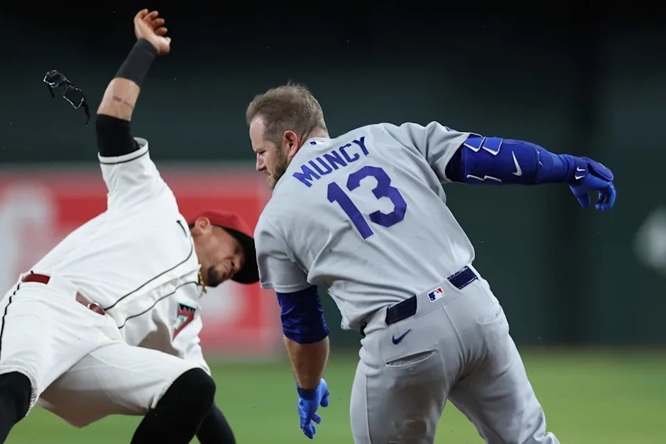 Max Muncy collides with Ildemaro Vargas at first base. Getty Images