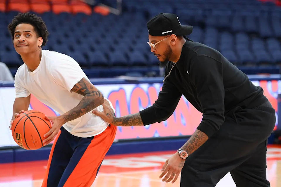 Jan 13, 2026; Syracuse, New York, USA; Syracuse Orange guard Kiyan Anthony (left) works with his father hall of fame member Carmelo Anthony (right) prior to the game against the Florida State Seminolesat the JMA Wireless Dome. Mandatory Credit: Rich Barnes-Imagn Images