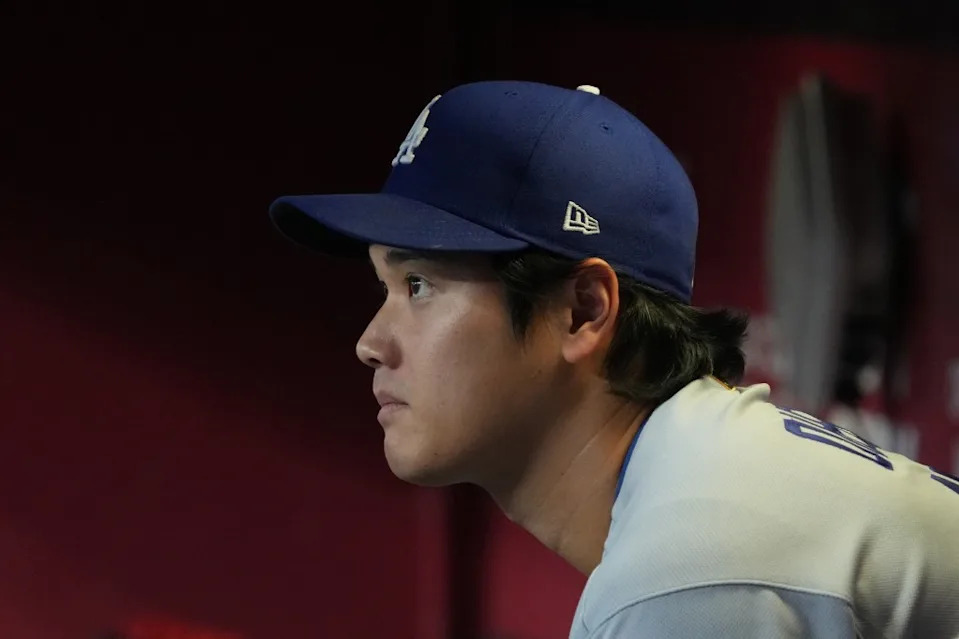 Shohei Ohtani sits in the dugout in the first inning against the Arizona Diamondbacks. AP Photo/Rick Scuteri