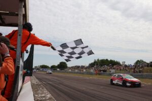 Cook holds off Sutton for opener win
