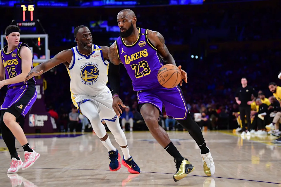 Los Angeles Lakers forward LeBron James (23) moves the ball against Golden State Warriors forward Draymond Green (23) during a January 2025 game.