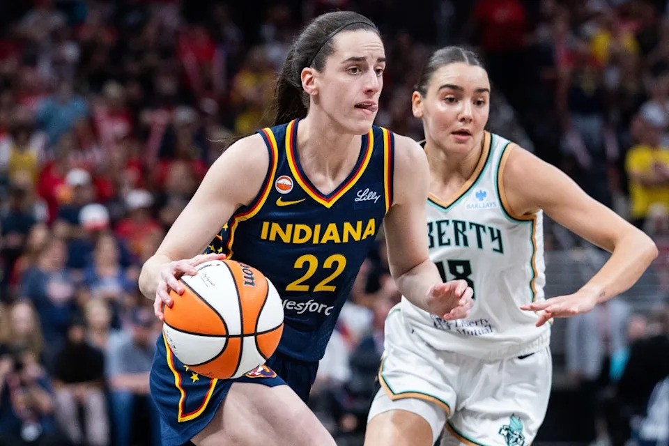 Indiana Fever guard Caitlin Clark (22) dribbles the ball while New York Liberty guard Pauline Astier (18) defends in the first half at Gainbridge Fieldhouse. IMAGN IMAGES via Reuters Connect